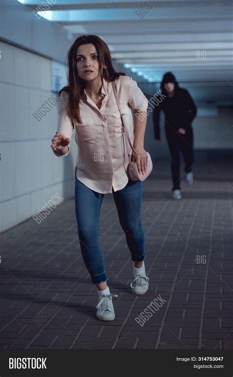 A girl running away from a perpetrator.