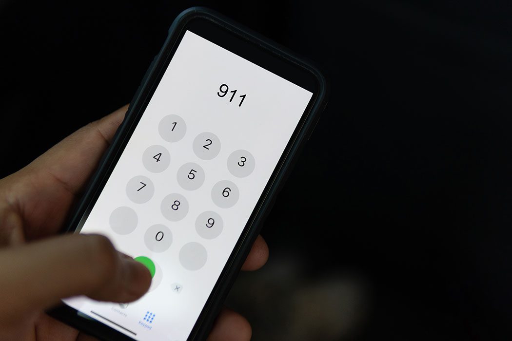A picture of someone calling 911.